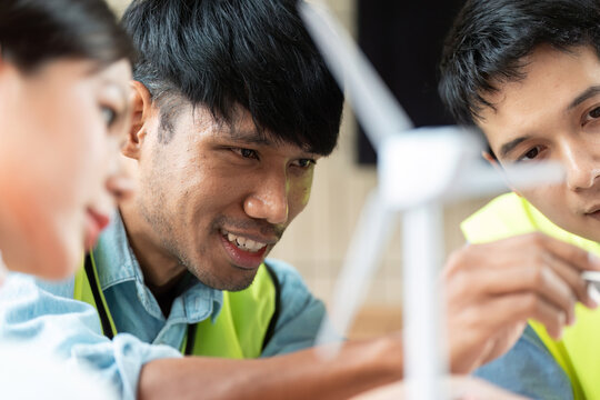 Sustainable Energy Planning. Team brainstorming innovative wind power solutions in a collaborative setting.