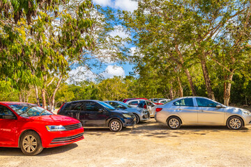 Parking lot with cars jungle to Kaan Luum lagoon Mexico.