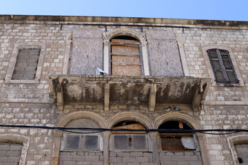 Fototapeta premium Ruins of old houses in the center of a big city
