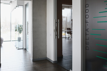 Modern office interior showing delta food company sign on frosted glass door