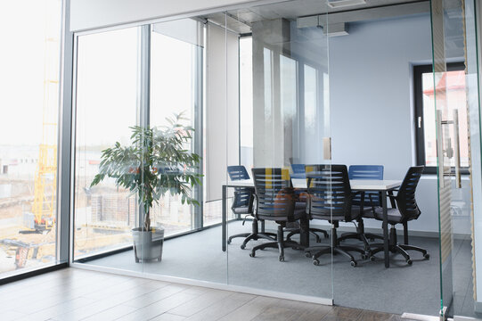 Modern office meeting room with glass walls and construction view