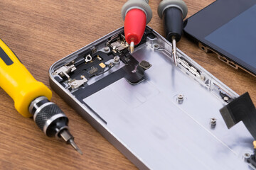 disassembled gadget, display, and special smartphone repair tools