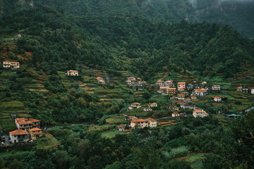 Green Mountains of Madeira with Charming Village Views. Lush forests blanket the hills. Nature, culture, and island life. 