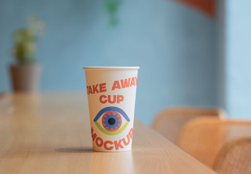 Clean mockup showcasing a white takeaway cup on wood.