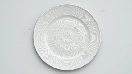 Elegant White Ceramic Plate with Textured Pattern on a Simple Background
