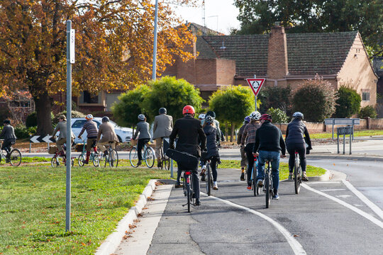 Cyclists on a Tweed Ride approaching a roundabout in a city