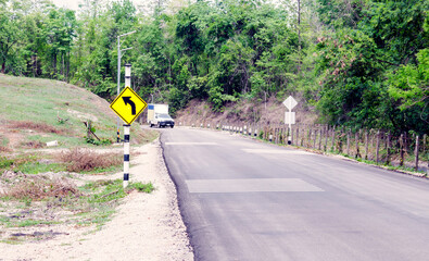 Traffic sign indicating a curve in a rural road