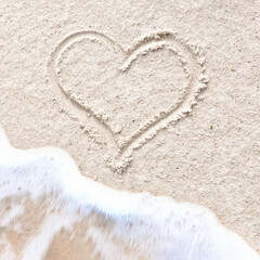 Heart drawn on the beach sand being washed away by a wave. Summer love