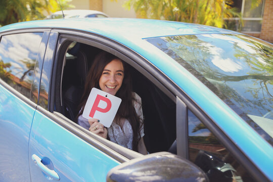 Teenage girl holding P plate
