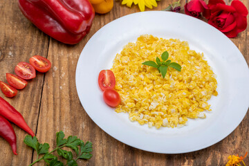 fresh scrambled eggs on white plate on breakfast table
