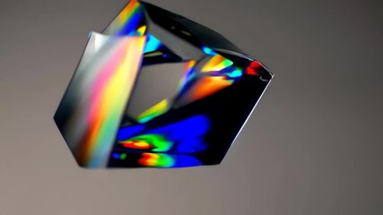 Rotating geometric prism with vibrant iridescent reflections on gradient background, abstract minimal 3D shape in optical dispersion animation loop - Powered by Adobe