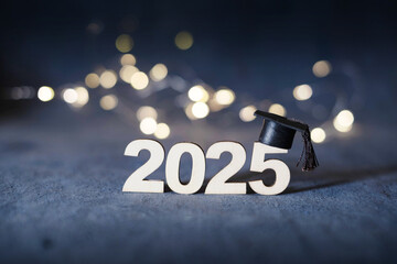 Number 2025 with graduation cap on dark background with bokeh. Class of 2025 concept