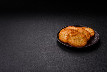 Potato hash browns, a meal with onions, cabbage in the form of fritters