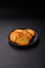 Potato hash browns, a meal with onions, cabbage in the form of fritters