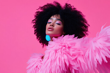 Studio shot of a fashion model wearing a pink feathered boa and turquoise earrings