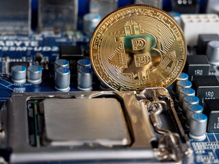 Bitcoin Cryptocurrency Coin on Computer Circuit Board