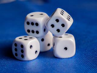 Dice Arranged on a Blue Table Surface for Game Play