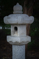 Stone lantern in a tranquil garden setting at dusk time