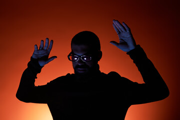 Striking summer vibes with a handsome man in stylish attire enjoying the warm glow of evening light