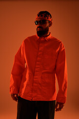 Handsome young man showcasing vibrant summer fashion in warm gradient lighting