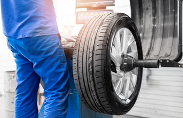 Professional tire balancing and alignment service in automotive workshop