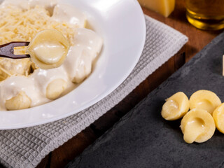 Potato gnocchi stuffed with cheese in white sauce