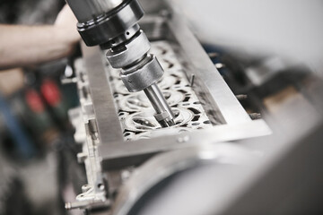 Fototapeta na wymiar Engine Valve Seat Repair in car workshop close up.