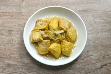 fried cabbage with slice soft yellow tofu vegetarian food on plate