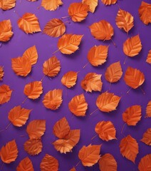 Metallic orange leaves scattered on violet  Geometric leaf pattern on vibrant background , composition, color
