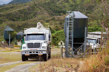 Feed Delivery Truck Preparing to Fill a Pig Feed Silo on a Livestock Farm