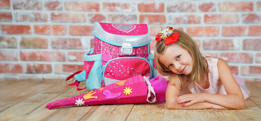 A happy little girl ready for school, first grade smiles at the camera. back to school.
