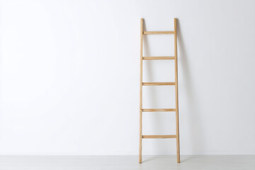 Wooden ladder leaning against a plain white wall in a minimalist interior space