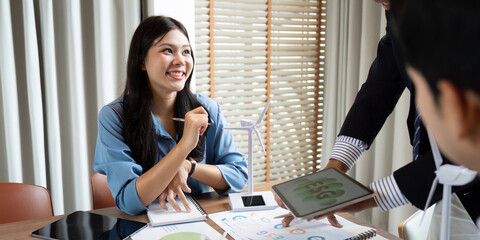 Sustainability and ESG. Smiling professional discussing ESG strategies in a collaborative office environment.