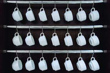 Rows of many empty white cups for coffee or tea in seminar event or meeting room