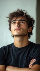 Obraz premium Portrait of a Young Man with Dark Hair and Thoughtful Expression