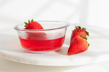 Chilled strawberry jelly served with whole berries