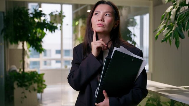 Thoughtful Asian doubtful woman pensive thinking puzzled businesswoman with documents girl female entrepreneur business employer manager choose search think brainstorm planning idea question thought