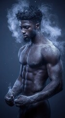 Toned man stands in a powerful pose as dust surrounds him. The dark skin contrasts the dust