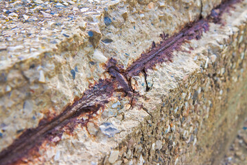 Old reinforced concrete structure with damaged and rusty metallic reinforcement bars