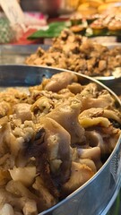 Close-Up of Delicious Cooked Meat Dishes at a Vibrant Asian Street Food Market Stall