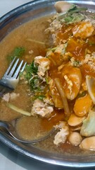 Fresh Seafood Dish with Savory Sauce and Crisp Vegetables Served in a Metal Bowl