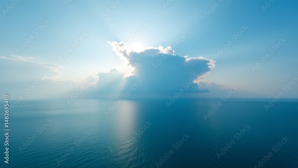 Poster sun shining through a fluffy cloud over a serene and calm ocean surface creating a tranquil atmosphe