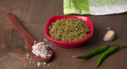 Coconut chutney in a bowl with raw coconut and green chilli ,Served with dosa, idli, vada
