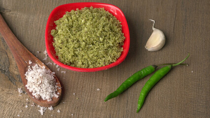 Coconut chutney in a bowl with raw coconut and green chilli ,Served with dosa, idli, vada
