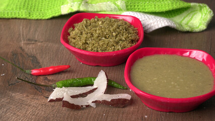 Coconut chutney in a bowl with raw coconut and green chilli ,Served with dosa, idli, vada
