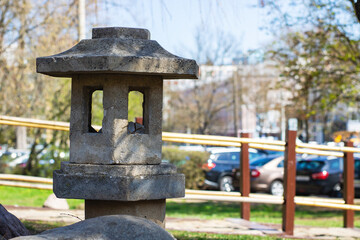 Fototapeta premium Stone Lantern Located in a Beautiful Urban Park Setting for All to Enjoy the Nature