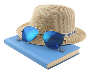 Stylish sun hat rests atop blue book, accompanied by pair of reflective sunglasses, creating perfect summer vibe for relaxation and reading