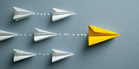 Several white paper airplanes follow a path, with a single yellow airplane leading the way, symbolizing innovation, leadership, and breaking from the norm