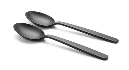 Minimalist composition featuring two sleek matte black spoons isolated on white