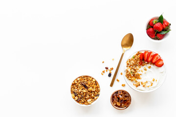 Flat lay composition with yogurt and muesli in bowl served with ingredients. Top view